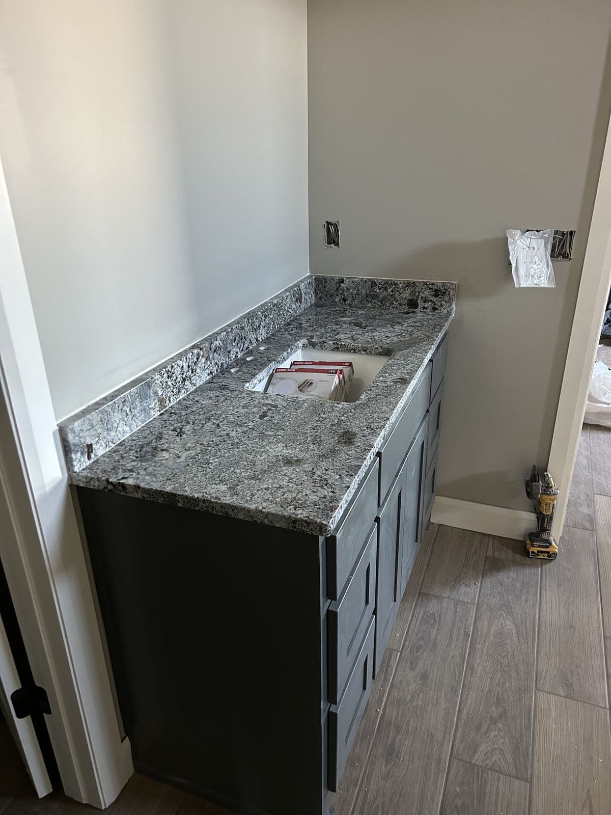 Granite island with gray cabinets
